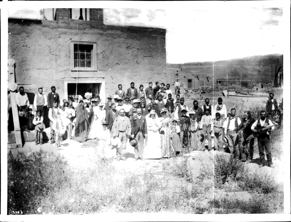 A wedding party and guests stand in front of the church at San Jose, New Mexico, ca.1898 (CHS-3923)