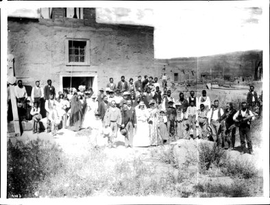 A wedding party and guests stand in front of the church at San Jose, New Mexico, ca.1898 (CHS-3923) photo