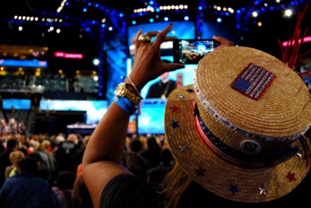 A woman records the invocation at the Democratic National Convention, Charlotte, North Carolina, September 4, 2012
