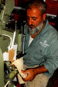 A worker at the Kabul Melli factory handcrafts combat boots (4919575166) photo