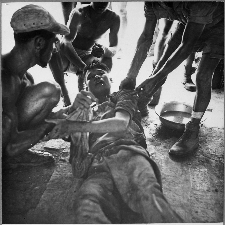 A wounded Vietminh prisoner is given first aid by Franco Vietnamese medicals after hot fire fight near Hung Yen, south o - NARA - 541968