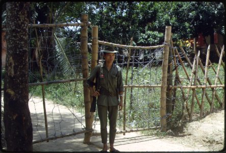 A young soldier from the Popular Forces stands gate guard duty in Vietnam. - NARA - 532459