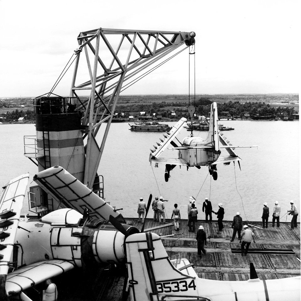 A-1G on crane of USNS Core (T-AKV-41) at Saigon c1965