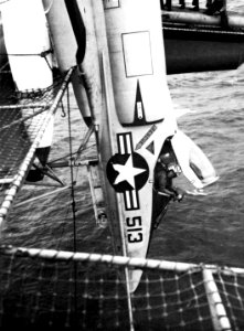 A-4 Skyhawk hanging over side of aircraft carrier photo