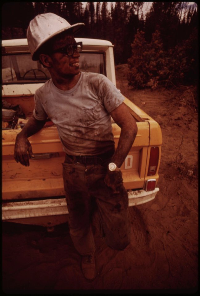 A-cat-skinner-in-the-burn-area-known-as-granite-fire-cat-skinners-chain-logs-to-caterpillar-tractors-the-cat-then-pulls-logs-to-landing-area-for-loading-onto-trucks-september-1973 7007001286 o