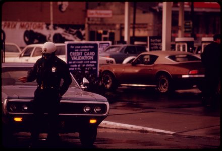 A-police-officer-in-portland-controlled-traffic-at-a-gasoline-station-that-was-limiting-its-sales-to-only-two-gallons-per-customer-in-december-1973-121973 4272499506 o photo