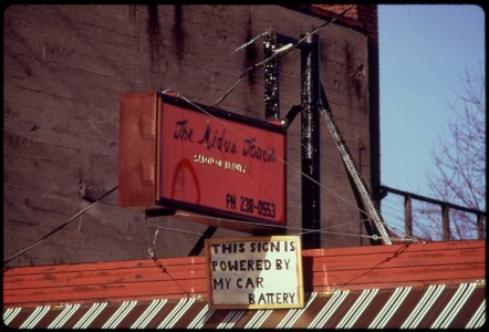 A-car-battery-operated-this-neon-advertising-sign-over-a-business-during-the-energy-crisis-in-december-1973-121973 4271738741 o