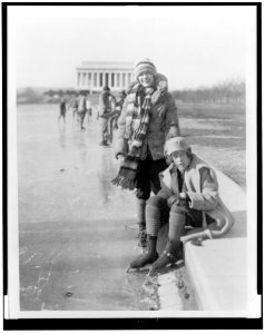 Abbey Jackson, seated, and Celene DuPuy ice skating on reflecting pool, with Lincoln Memorial in background LCCN96509163