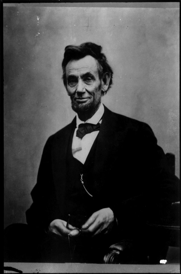 Abraham Lincoln, half-length portrait, seated, with pencil and spectacles retouched LCCN2002725277