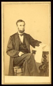 Abraham Lincoln, U.S. President. Seated portrait, holding glasses and newspaper, Aug. 9, 1863 LCCN2008680388