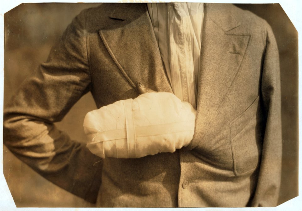Accident case - Man with hand crushed by flywheel at Offset Litho Co. because his helper (a boy of 17) disobeyed instructions and pushed wrong lever. LOC nclc.05102