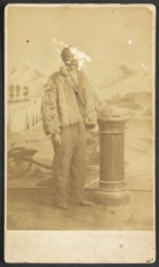African American man in a fur coat, full-length portrait, facing front LCCN2010647916