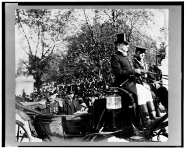 Adm. George Dewey, in uniform, riding in a horse-drawn carriage with an unidentified man LCCN98503212