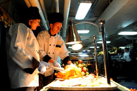 Adm. Jonathan Greenert, right, carves a Thanksgiving turkey with his wife, Darleen. (8221424700)