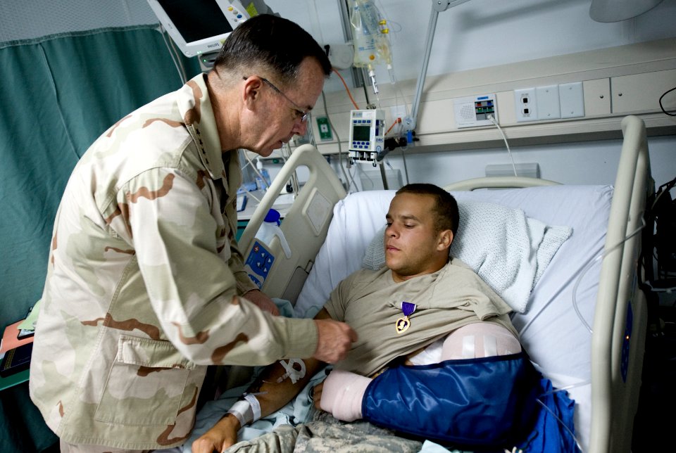 Adm. Mike Mullen presents a Purple Heart medal to an Army soldier at Bagram Air Field, Afghanistan, 2009 (090714-N-0696M-355)