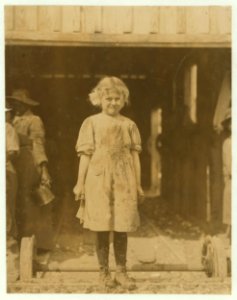 Adult shucker whowing (i.e., showing) the rough, dirty shells and the 'finger-stalls' because 'Our fingers get so sore.' Varn & Platt Canning Co. LOC nclc.01011