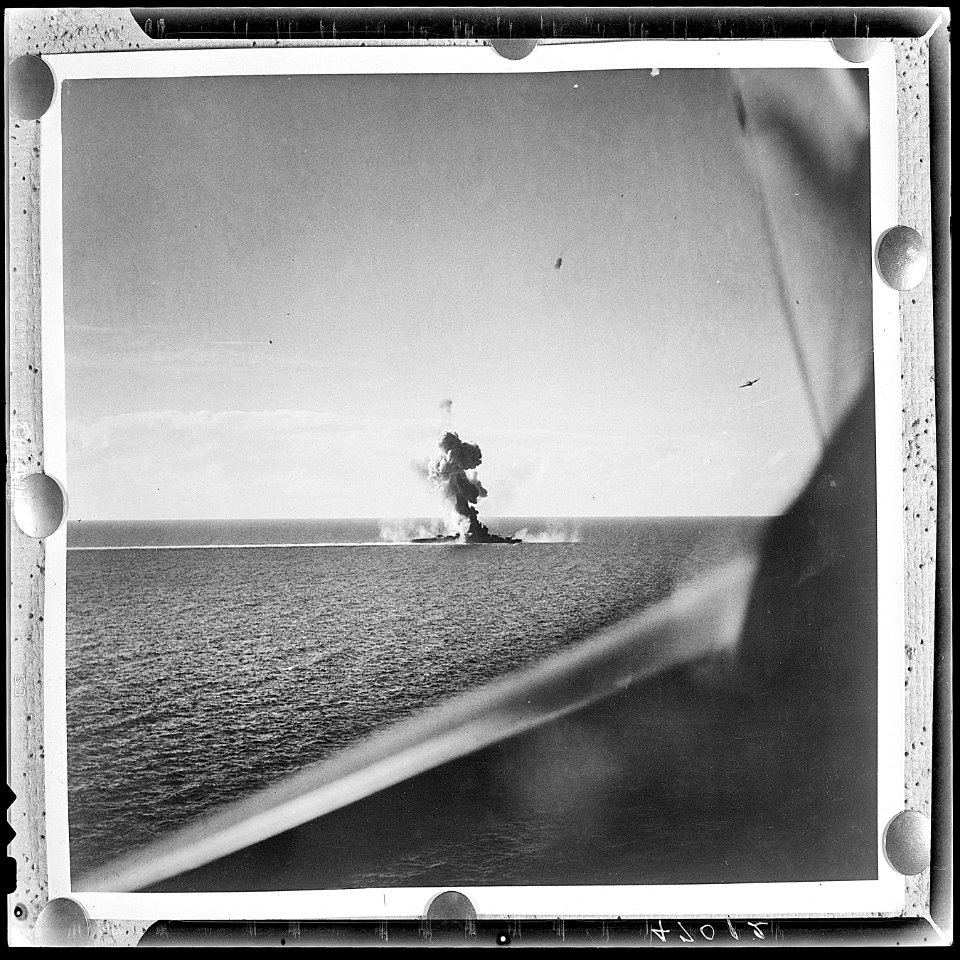 Aerial of US invasion of Engebi Island in Eniwetok atoll. Flares (left) signal fleet to lift bombardment so that... - NARA - 520614