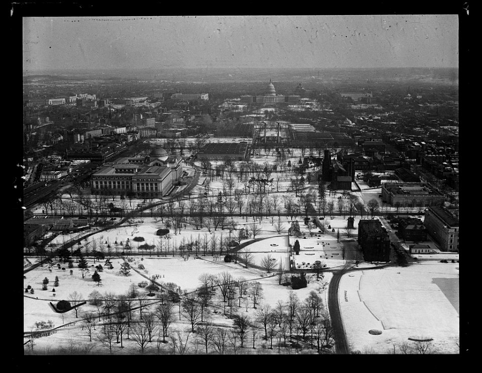 Aerial view looking toward U.S. Capitol with snow, Washington, D.C. LCCN2016891199