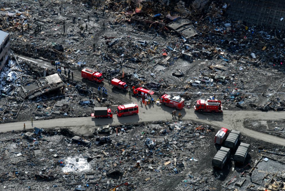 Aerial view of Japanese Ground Self-Defense Force personnel and disaster relief crews searching Otsuchi, Japan