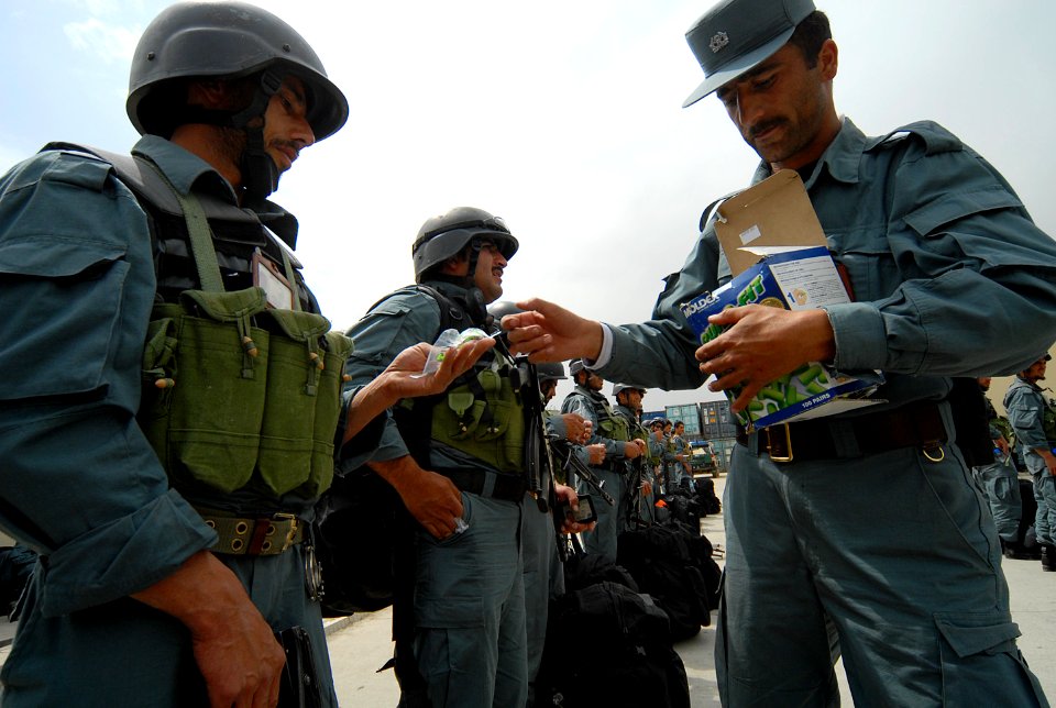 Afghan National Civil Order Police (ANCOP) lieutenant, right, passes out hearing protection (4527955699)