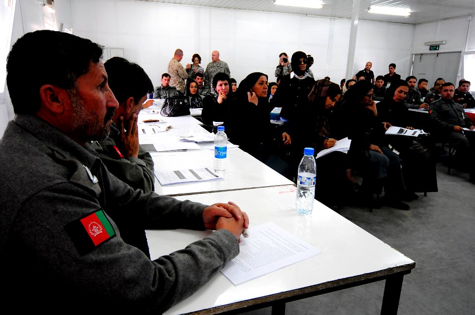 Afghan National Police (ANP) officers listen and compare notes (4508199680)