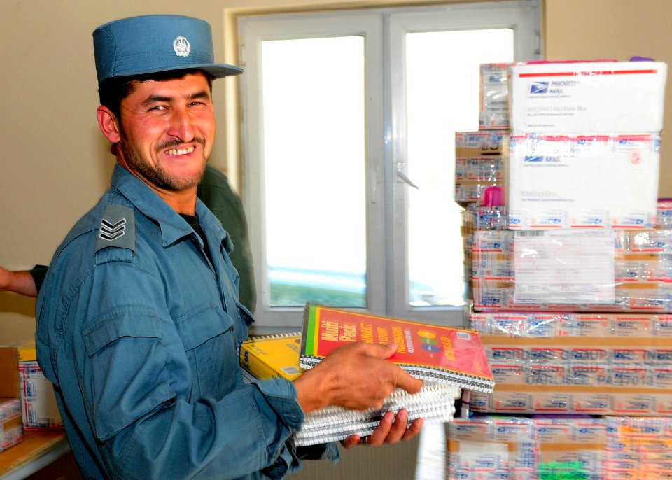 Afghan National Civil Order Police Sergeant helps load boxes of school supplies to be distributed to a local school. (4677625215)