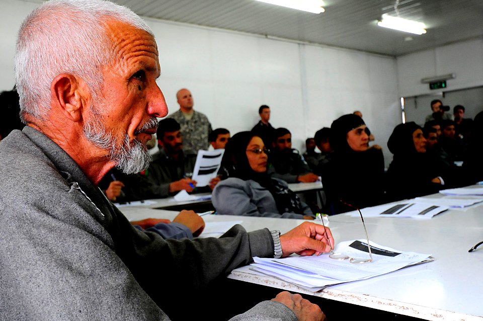 Afghan National Police (ANP) officers listen and compare notes (4507560495)