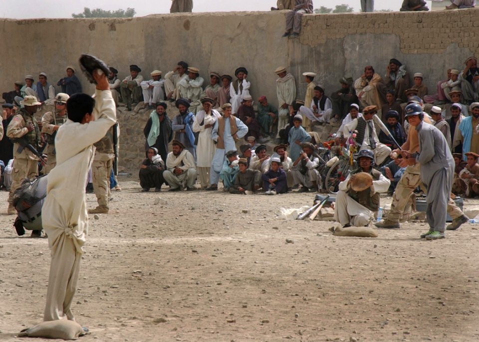 Afghan teens playing American baseball game