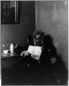 African American man holding newspaper LCCN2011660969