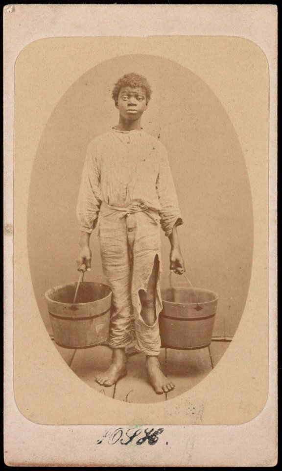African American boy, possibly a slave, holding two buckets) - Isaac Haas, photographer & dealer in stereoscopic views, Green Cove Springs, Fla LCCN2017659659