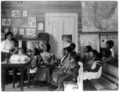 African American children and teacher in classroom studying corn and cotton, Annie Davis School, near Tuskegee, Alabama LCCN2001703735