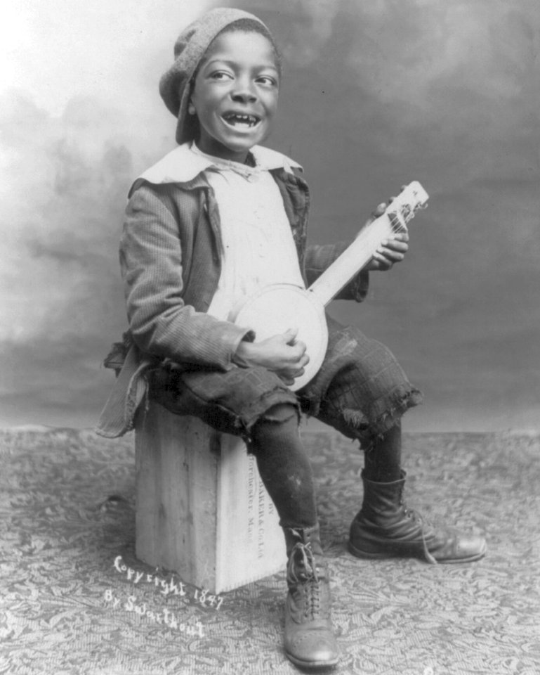 African American child with banjo in 1897 detail, from- I's a Little Alabama Coon LCCN2006687462 (cropped)