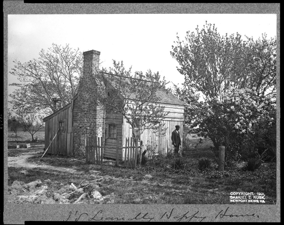 African American man in front of small house LCCN97508261