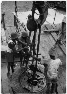 Africa. Gabon, French Equatorial Africa. Native workers assemble drill pipes, the rotary table comes from Beaumont... - NARA - 541653 photo