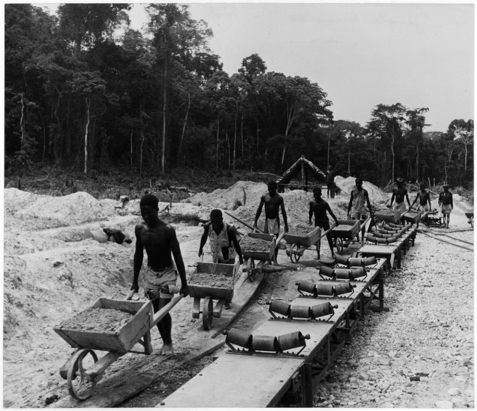 Africa. French Equatorial Africa. The old and the new - almost. The wheelbarrow express transports loads of... - NARA - 541650
