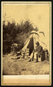 African American man, sitting outside a military camp tent LCCN2010647923