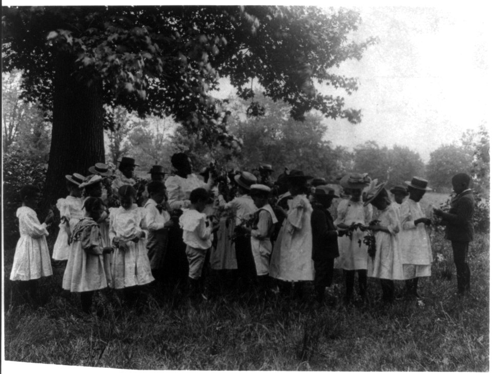 African American school children and teacher, studying leaves out of doors LCCN2001699120