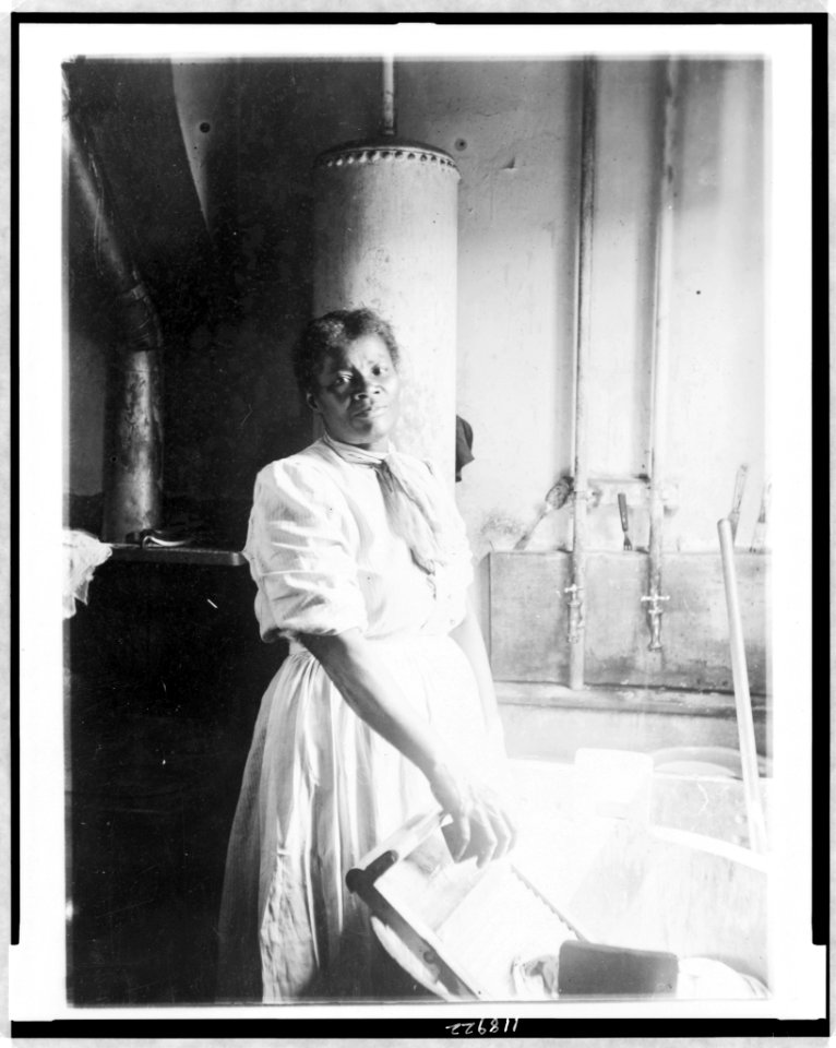 African American woman, three-quarter length portrait, standing, facing front, doing laundry at wash tub, in Washington, D.C. or New York LCCN97510100