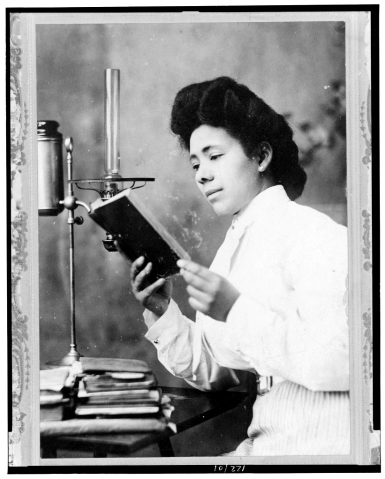 African American woman, half-length portrait, facing left, reading book LCCN98519372