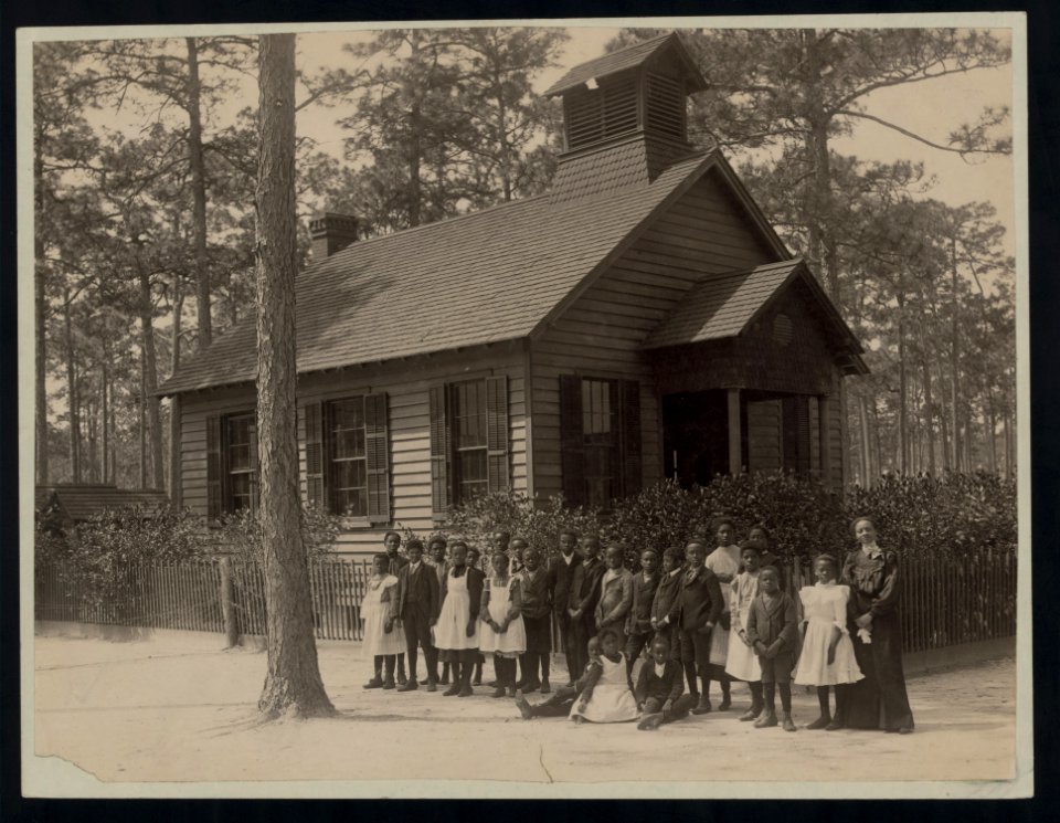 Africian American school children posed with their teacher outside a school, possibly in South Carolina LCCN2007676239