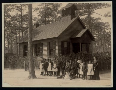 Africian American school children posed with their teacher outside a school, possibly in South Carolina LCCN2007676239