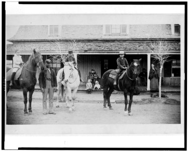 Afro-American enlisted man standing by three officers' children on horseback, Fort Verde, Arizona LCCN92513329
