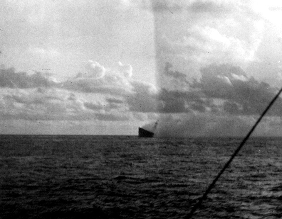 Aft view of the burning and listing USS Hornet (CV-8) during the Battle of Santa Cruz Islands, 26 October 1942 (80-G-33901)