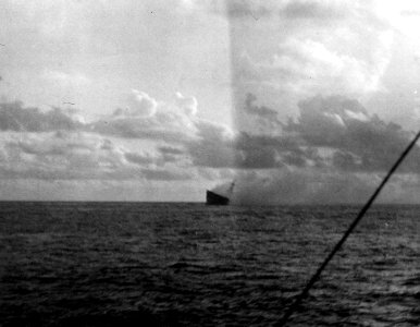 Aft view of the burning and listing USS Hornet (CV-8) during the Battle of Santa Cruz Islands, 26 October 1942 (80-G-33901)