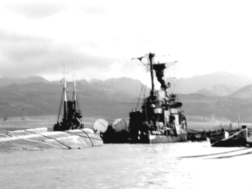 Aft view of the listing USS Raleigh (CL-7) at Pearl Harbor on 7 December 1941 (NH 97401)