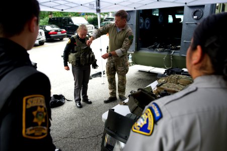 Agent demonstrates tactical vest to law enforcement explorers photo