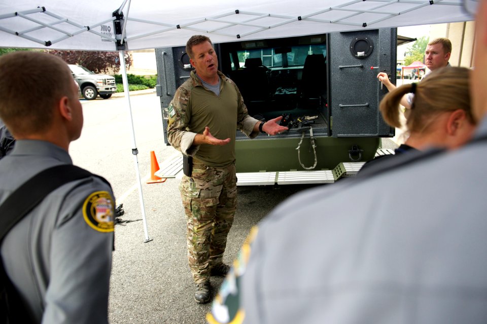 Agent speaks to onlooking law enforcement explorers