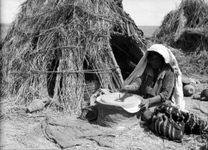 Agriculture, etc. Primitive methods of rubbing and grinding wheat. Woman grinding with present-day hand mill. Before her modest home on southern Sharon LOC matpc.15642