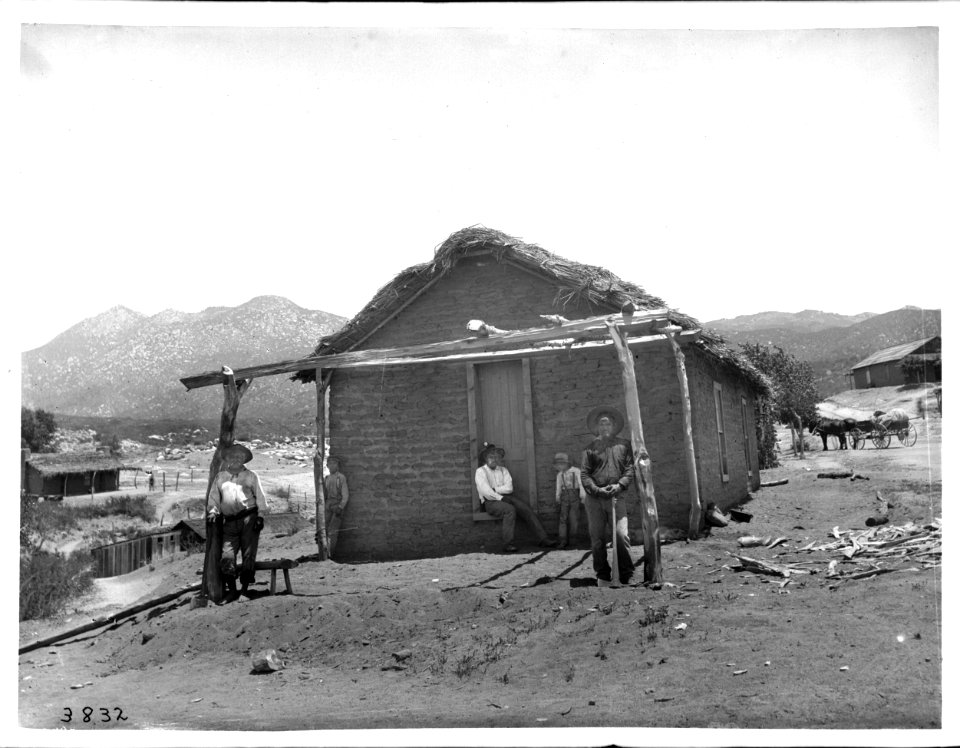 Agua Caliente Indian man, Simon Cibinoat, and his son, Trincoline, in front of their adobe dwelling, 1903 (CHS-3832)