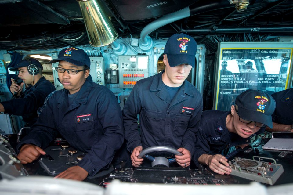 Ailors man the helm and lee helm in the pilot house of USS Essex. (17101666985)